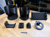 Seat Back Attachment System parts laid out on table showing all available attachments for Rivian R1S and R1T